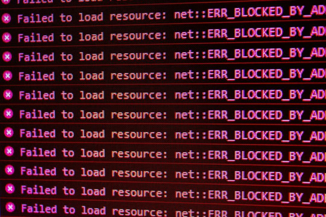 题图:一个终端窗口里刷满了红色的 net::ERR_BLOCKED_BY_AD… 报错,像是部署脚本连续失败时的输出
